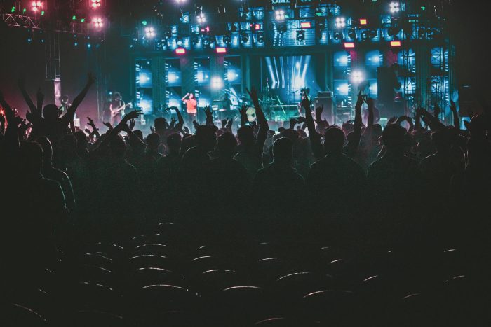 Energetic crowd enjoying a live music concert with colorful lights in Contai, West Bengal, India.